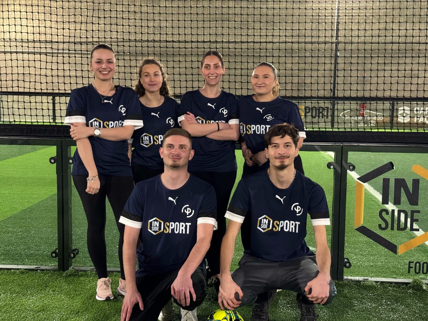 Team in Inside Sport shirts on an indoor football pitch