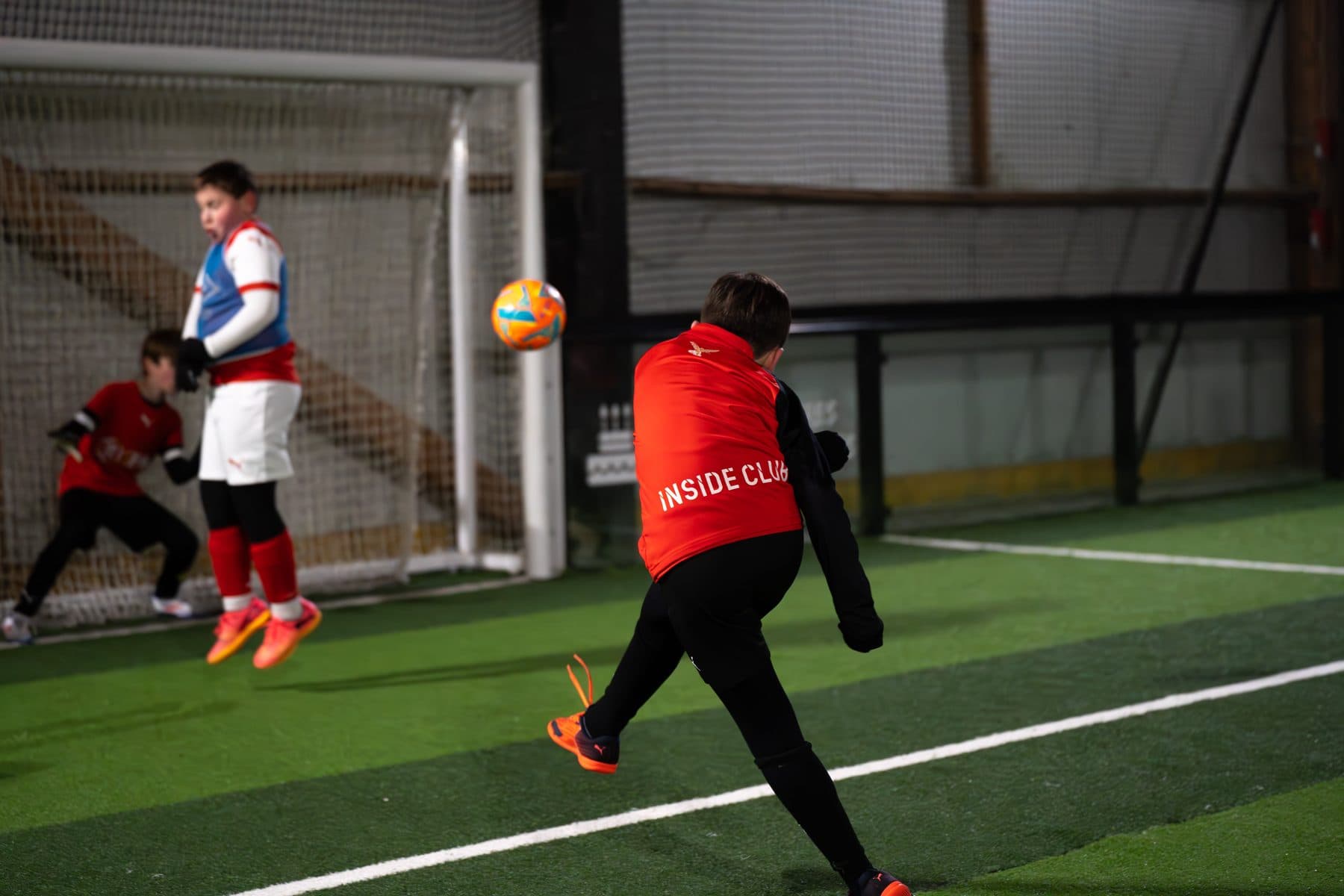Children playing football on an Inside Sport indoor pitch in Reims