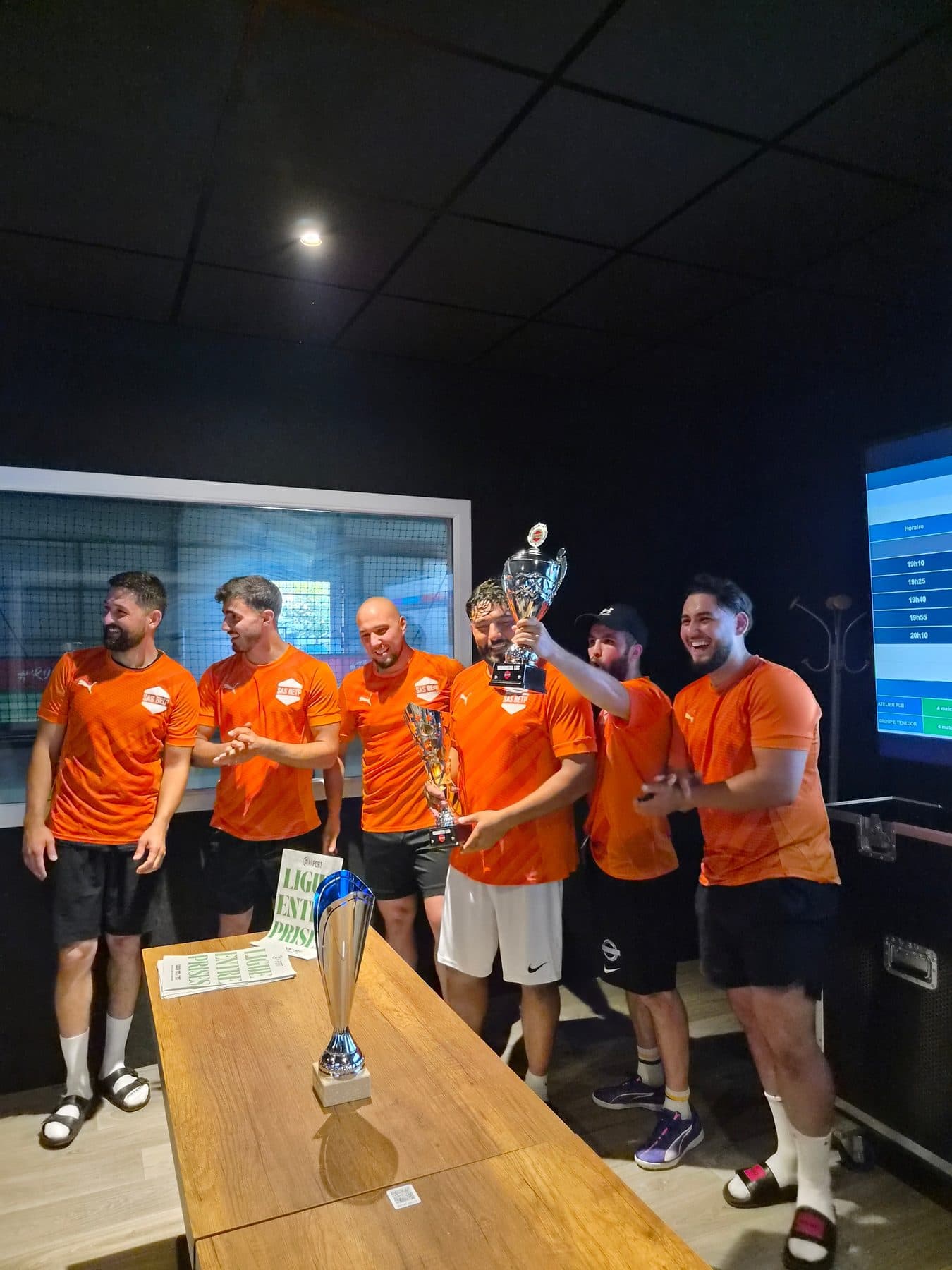 Winning Corporate League team posing with the trophy