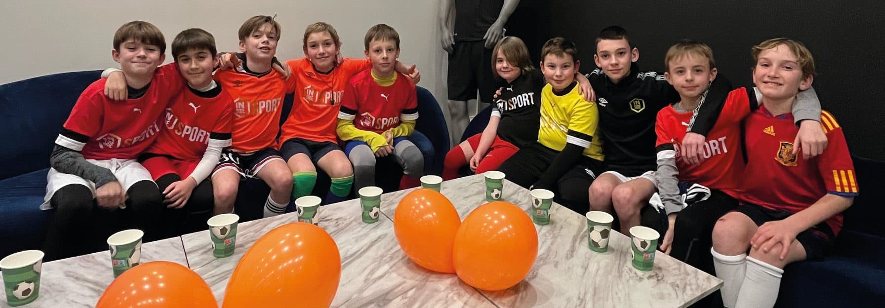 Group of children gathered around the birthday table at Inside Sport