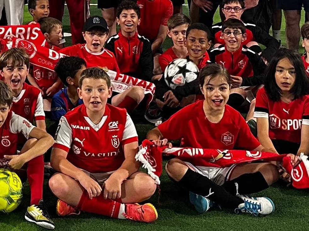 Young Insiders in Stade de Reims kit gathered on the pitch